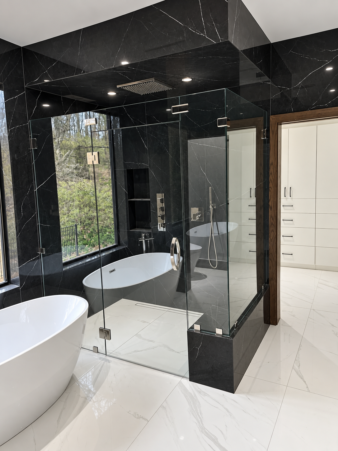Bathroom with black stone tile, glass shower and freestanding tub