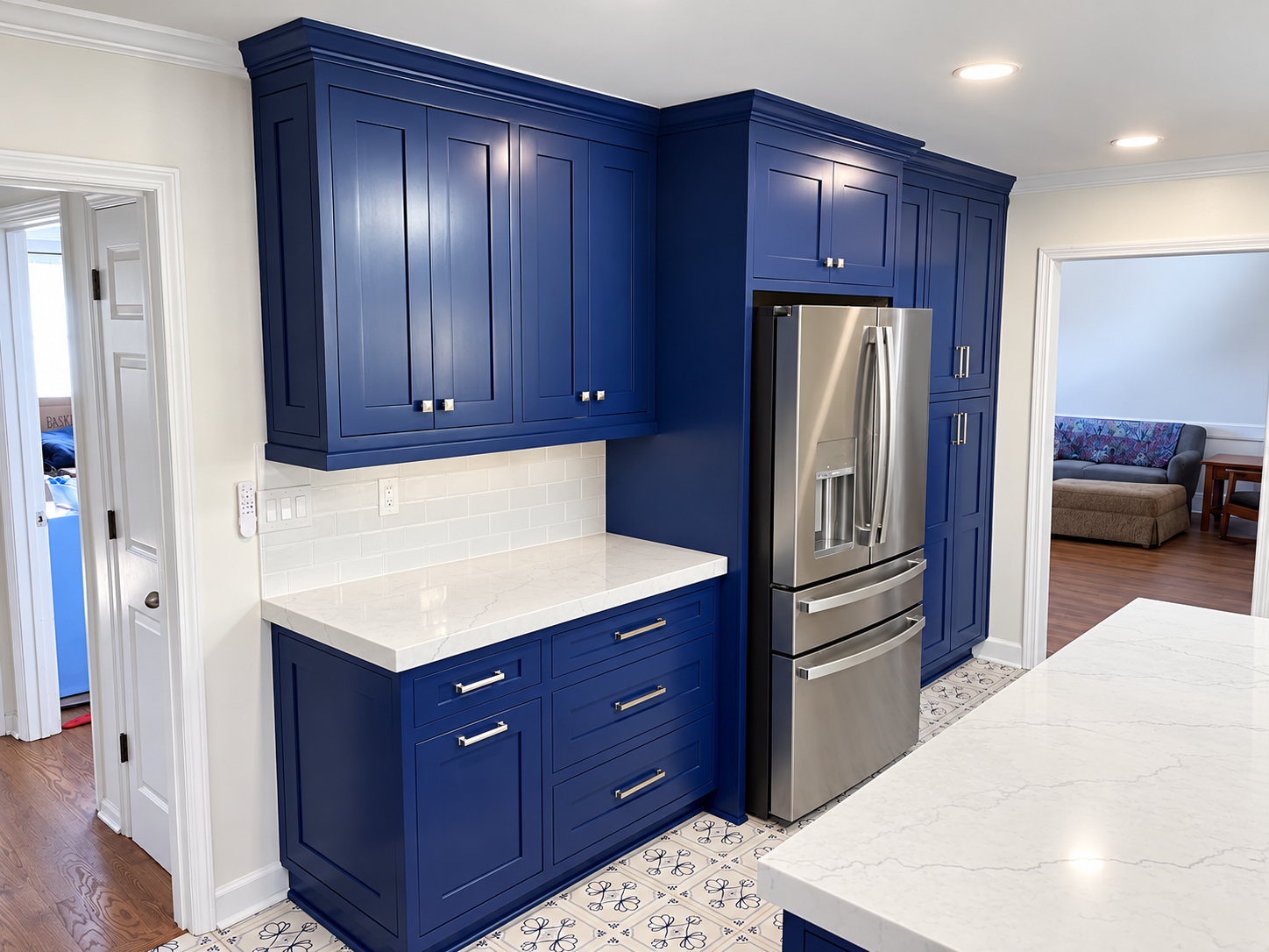 Blue cabinetry and patterned flooring in remodeled kitchen