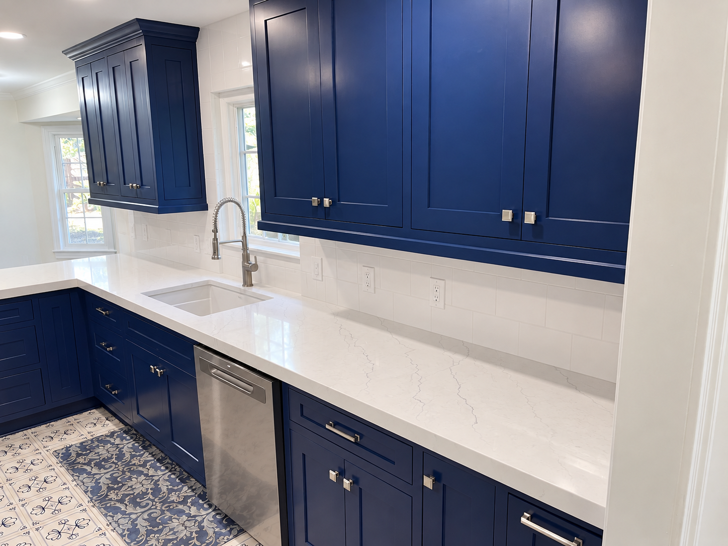 Blue kitchen with cleared counters and digitally visualized white window trim