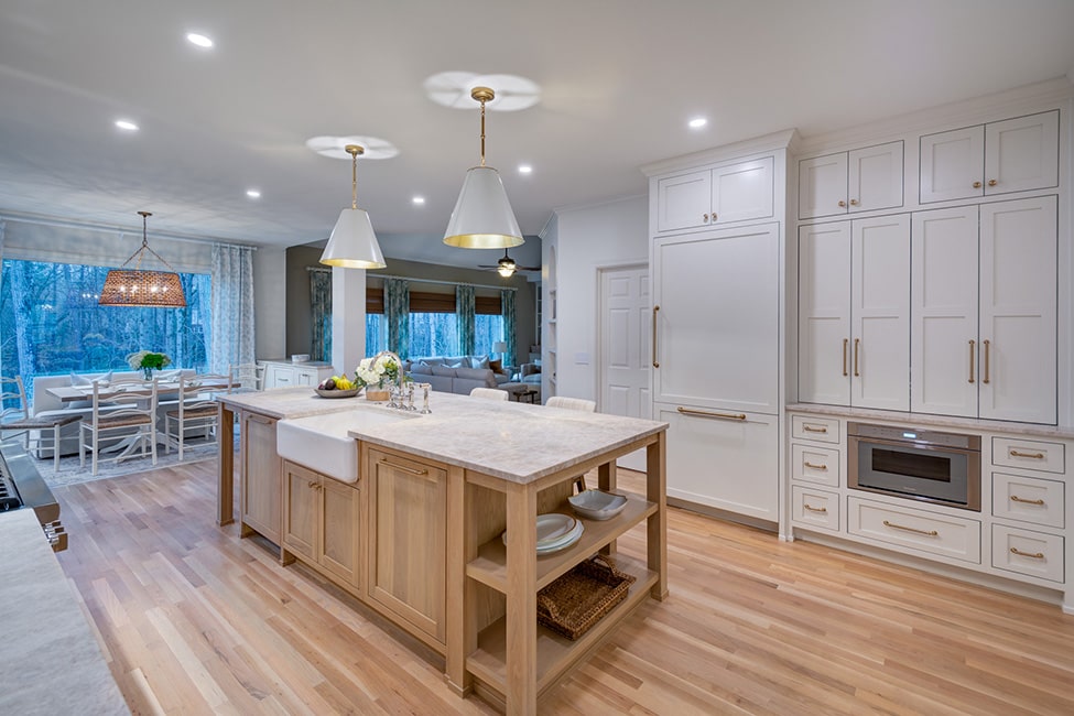 White kitchen cabinetry and wood island