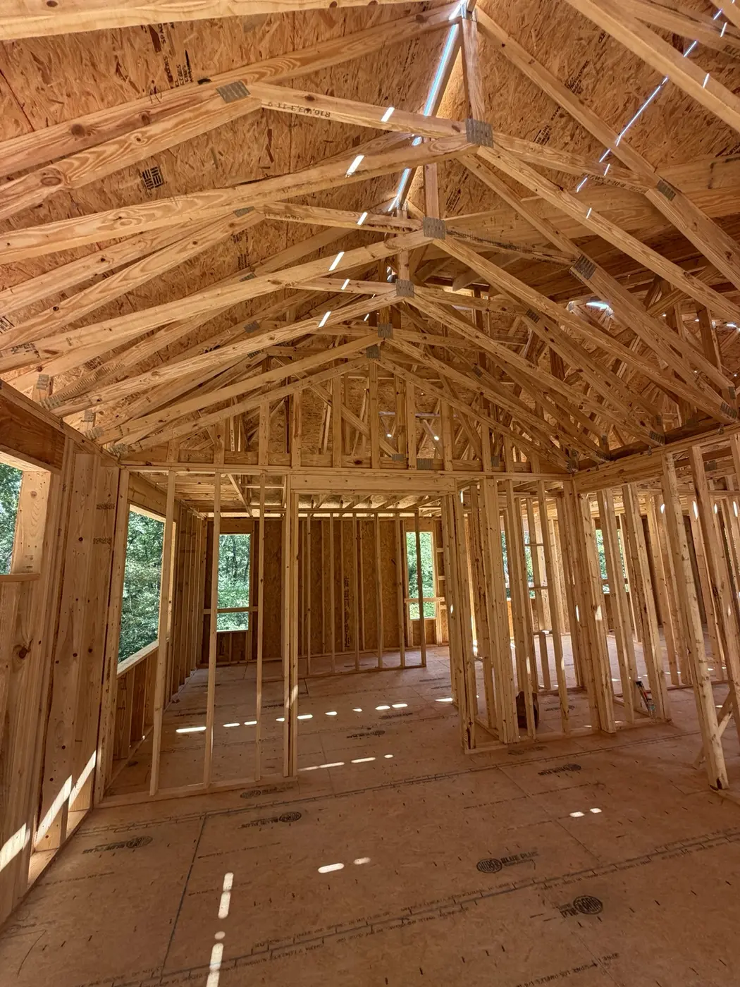Interior roof trusses and framed rooms in an active Norcross residential construction project